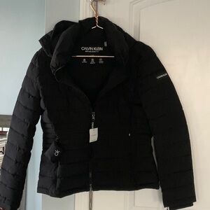 Calvin Klein black packable puffer jacket with hood. Size large. New with tags.